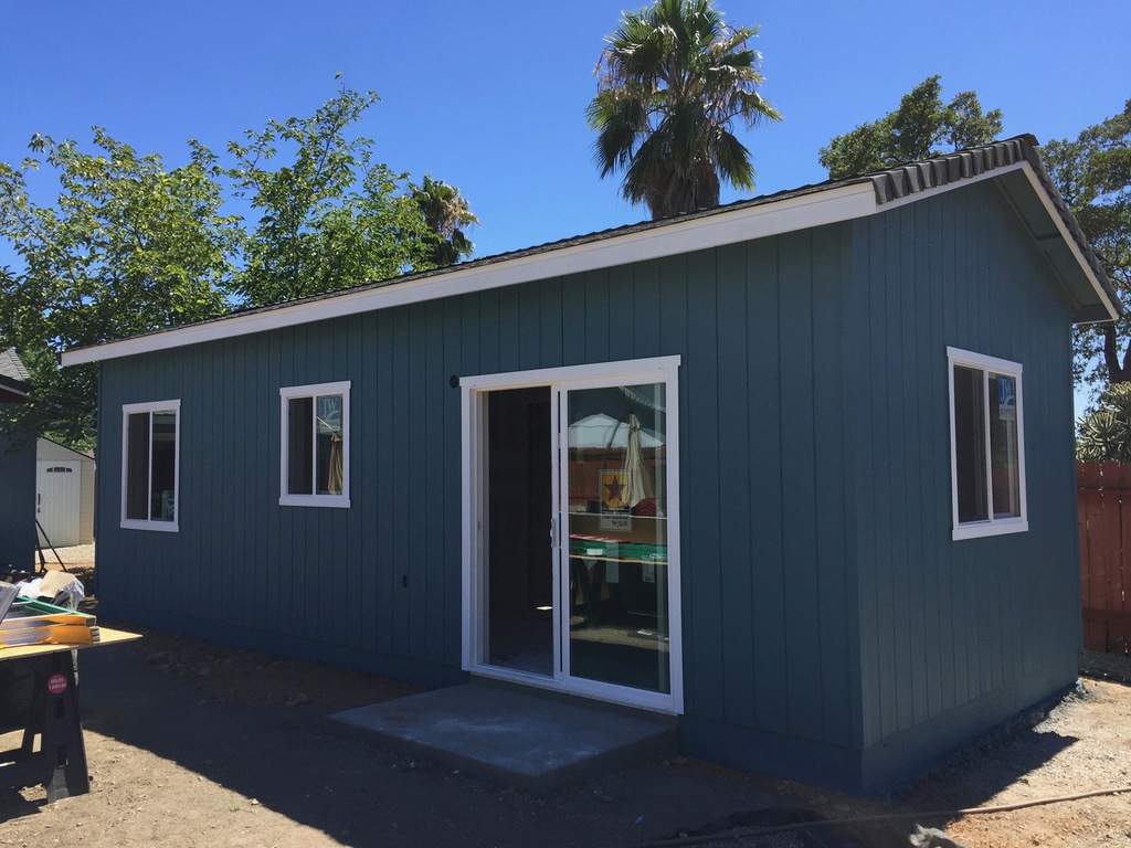 Backyard studio building painted deep teal with white trim by Talbot Painting in Redding