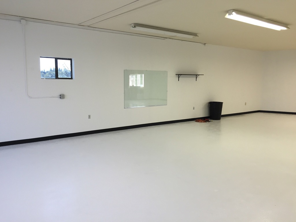 Finished commercial space in Redding with white walls, black baseboard and freshly coated floor