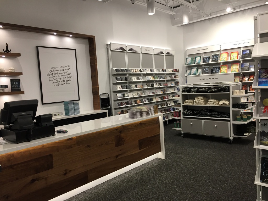 Finished retail store interior in Redding painted by Talbot Painting, white walls with wood checkout counter and display shelving