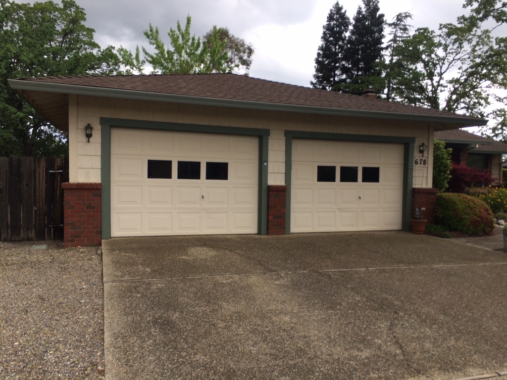Detached garage with faded green trim before exterior painting in Redding
