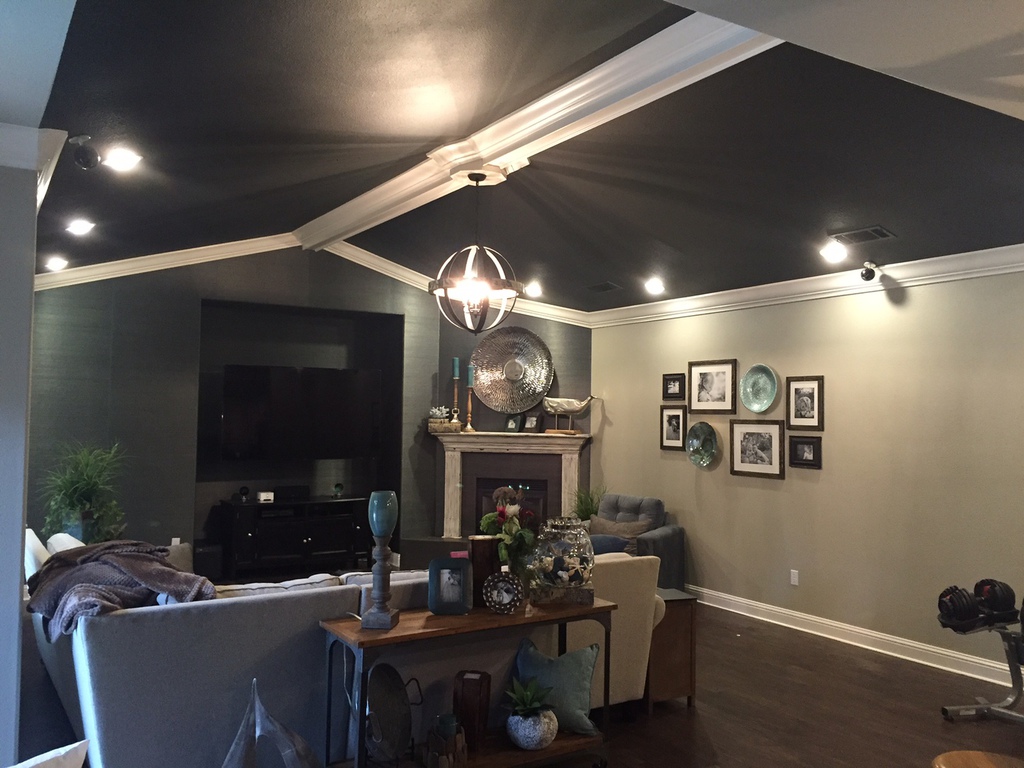 Living room interior painted by Talbot Painting in Redding with a dark accent ceiling and crisp white crown molding