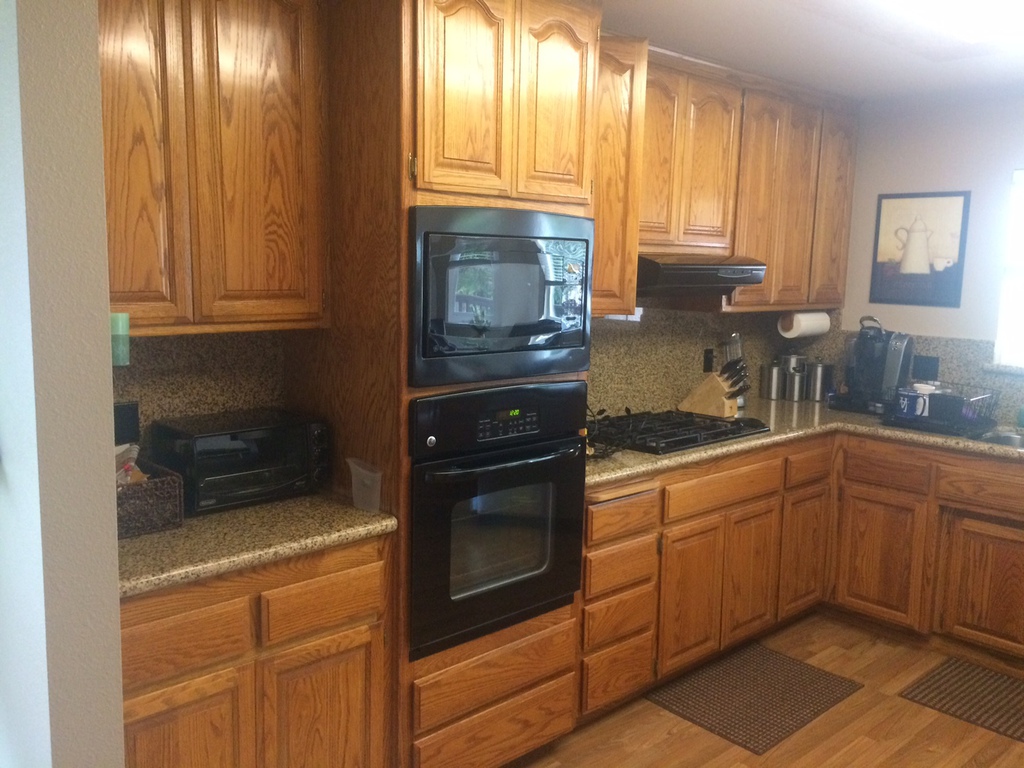 Kitchen with original oak cabinets before refinishing in a Redding home